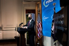 US President Joe Biden waits to speak during a climate change virtual summit from the East Room of t...