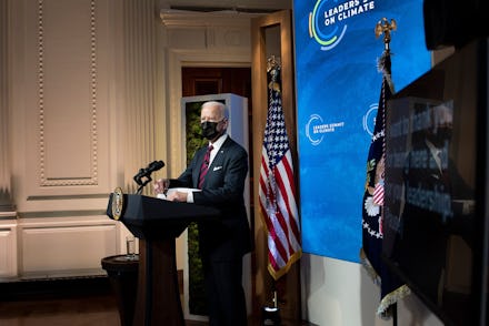 US President Joe Biden waits to speak during a climate change virtual summit from the East Room of t...