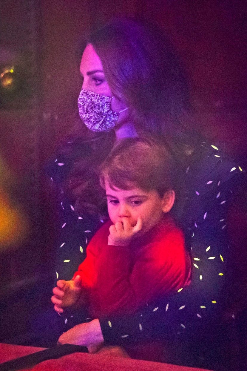 Prince Louis cuddles with his mom at Christmas.