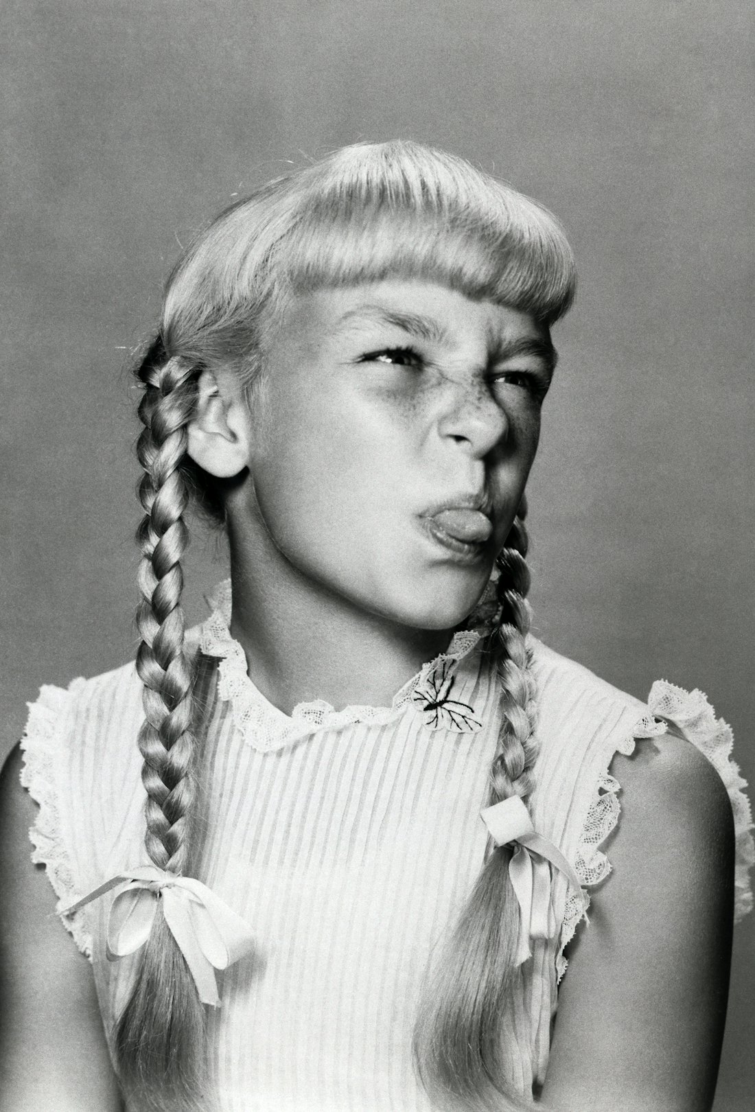 (Original Caption) 1957- Hollywood, CA: Patty McCormack sticking out her tongue during a scene in th...