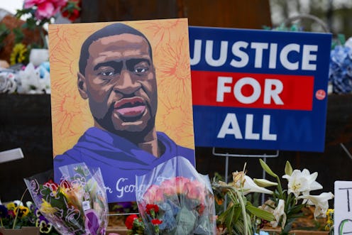 MINNEAPOLIS, MINNESOTA - APRIL 21: People lay flowers at a memorial in George Floyd Square in Minnea...