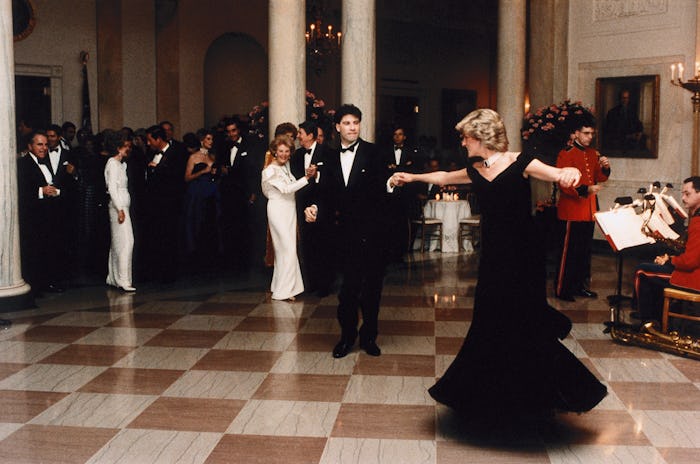 John Travolta twirls Princess Diana on the dance floor while at a White House banquet. Ronald and Na...