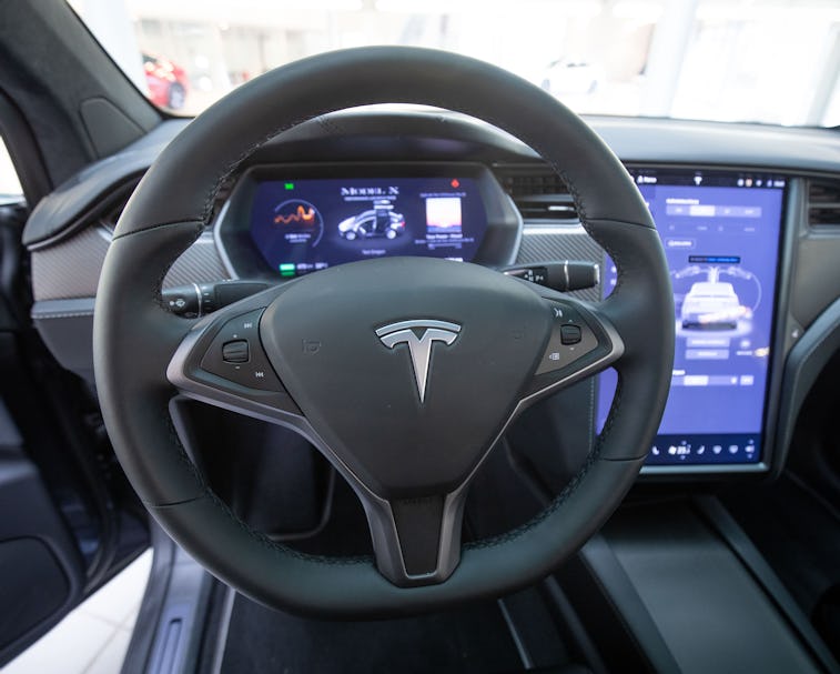 21 October 2020, Hamburg: View into the interior with steering wheel and display of a Tesla Model X ...