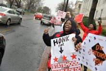 WASHINGTON, DC FEBRUARY 11:
Supporters for DC Statehood cheer as drivers honk their horns during t...
