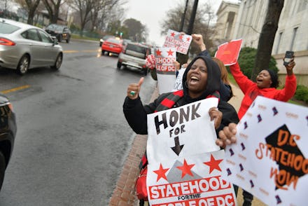 WASHINGTON, DC FEBRUARY 11:
Supporters for DC Statehood cheer as drivers honk their horns during t...