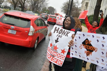 WASHINGTON, DC  FEBRUARY 11: 
Supporters for DC Statehood cheer as drivers honk their horns during t...