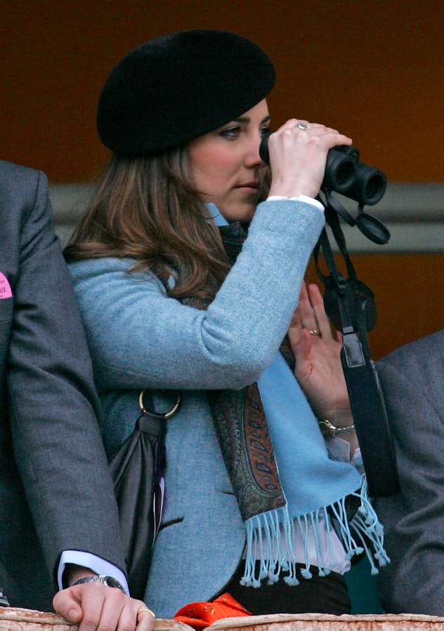CHELTENHAM, UNITED KINGDOM - MARCH 16:  Kate Middleton uses binoculars to watch the Gold Cup horse r...