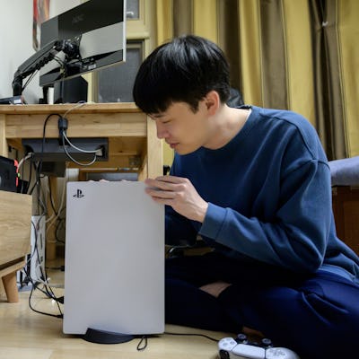 In a photo taken on November 12, 2020, a gamer sets up the new Sony Playstation PS5 at his home in S...
