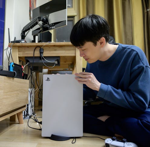 In a photo taken on November 12, 2020, a gamer sets up the new Sony Playstation PS5 at his home in S...