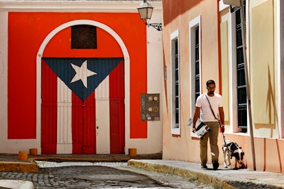 SAN JUAN, PUERTO RICO - OCTOBER 2: Celso Melendez, age 25, and his dog Popeye live in Old San Juan, ...