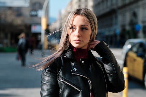 woman in the city looking fashionable in a leather jacket