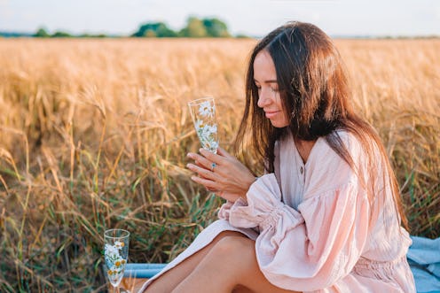 Beautiful woman in wheat field on picnic.