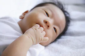 baby chewing on fingers