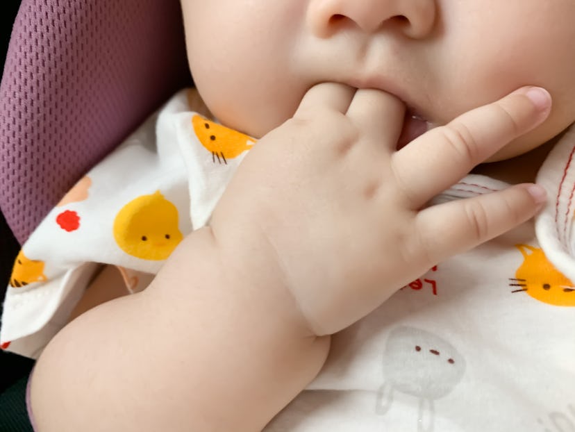 baby chewing on fingers