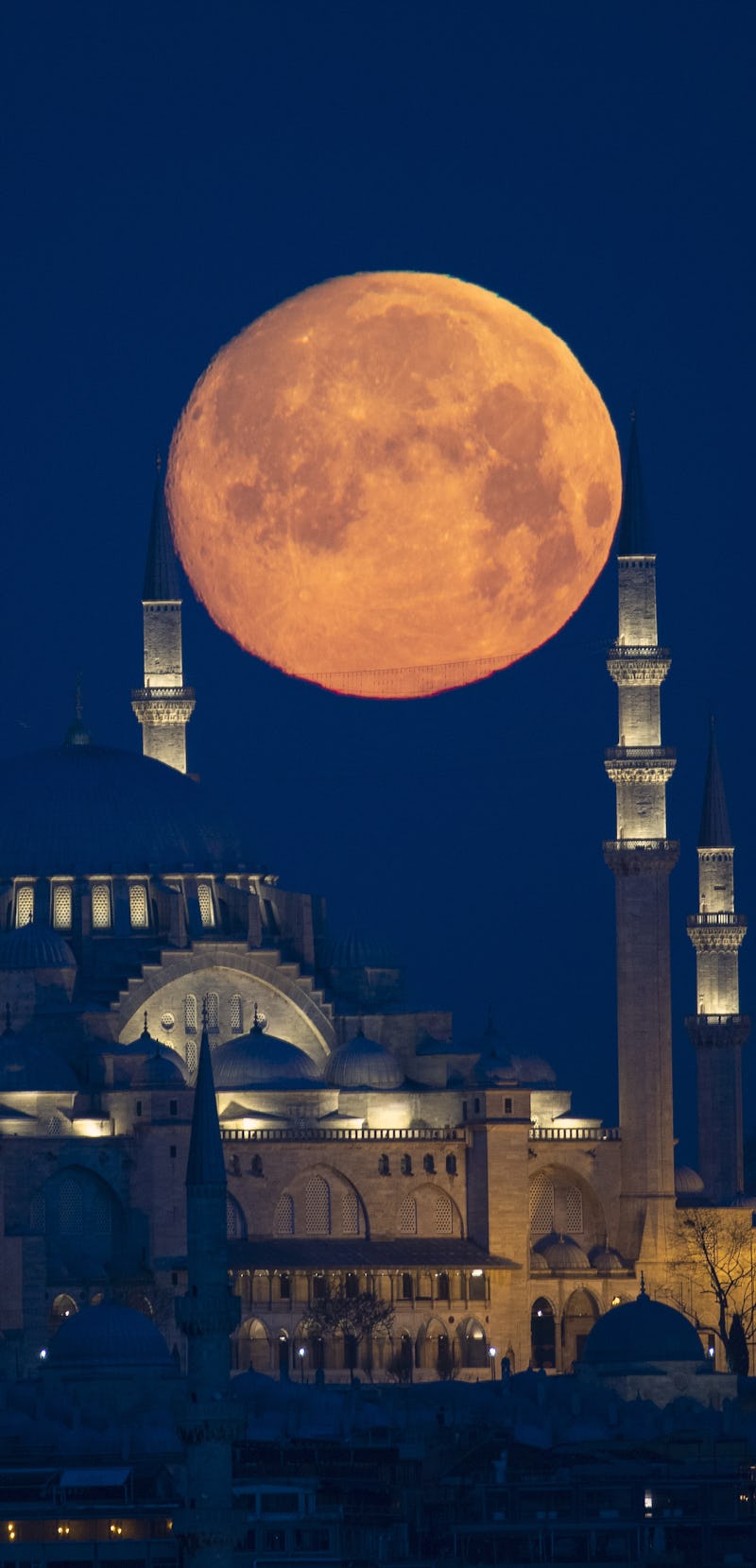 ISTANBUL, TURKEY - APRIL 26: Full moon rises over the Suleymaniye Mosque during the holy Islamic fas...