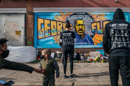 MINNEAPOLIS, MN - APRIL 20: People pay their respects at the mural of George Floyd at the intersecti...