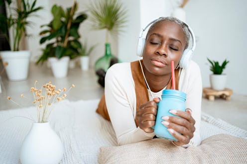 A woman listens to a Twitter Space audio conversation