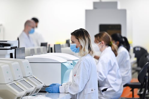 Laboratory technicians work to process samples to test for the novel coronavirus Covid-19, at Biogro...