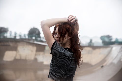 Young woman in the rain at a skate park. San Diego, CA. January 2019