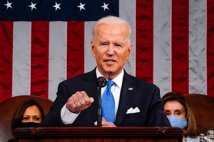 US President Joe Biden, flanked by US Vice President Kamala Harris (L) and Speaker of the House of R...