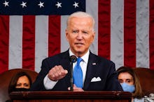 US President Joe Biden, flanked by US Vice President Kamala Harris (L) and Speaker of the House of R...