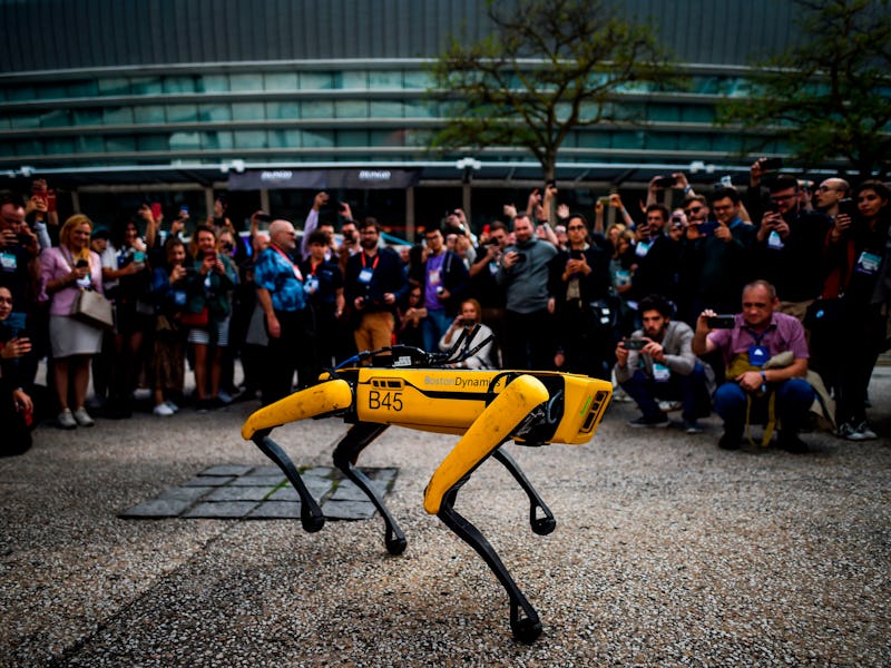 People take pictures and videos of Boston Dynamics Robot Dog named "Spot" during a presentation on t...