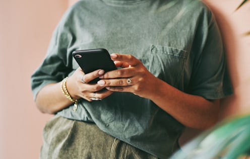 A person texts Crisis Text Line wearing a green shirt. Crisis text line data showed a 20% increase i...