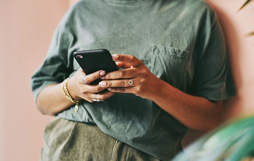 A person texts Crisis Text Line wearing a green shirt. Crisis text line data showed a 20% increase i...