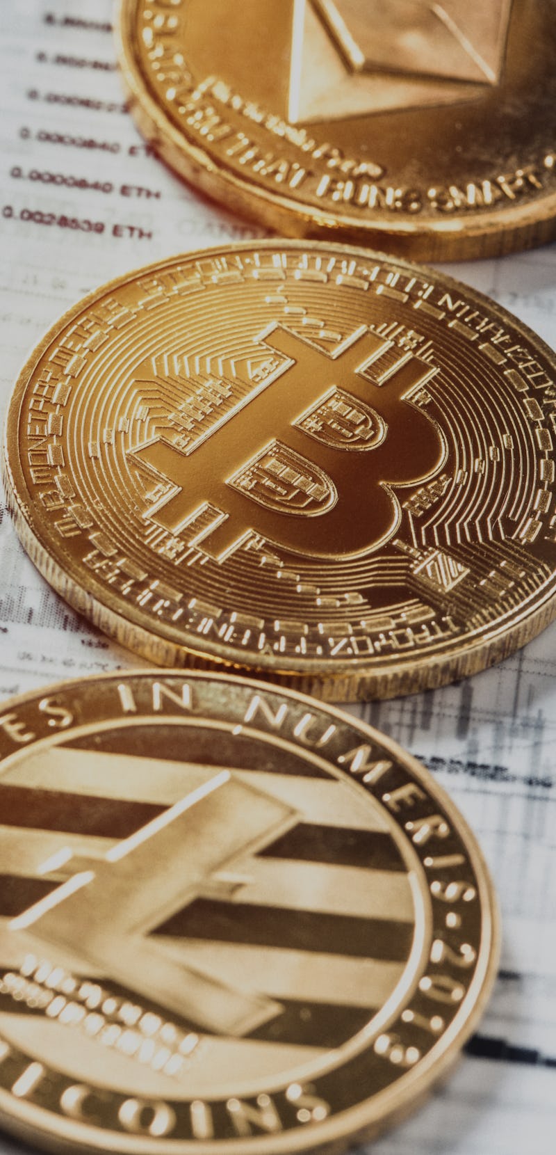 Crypto Currency Trading Techniques. Charts analytics printed on tracing paper.
Studio shot of a Bitc...