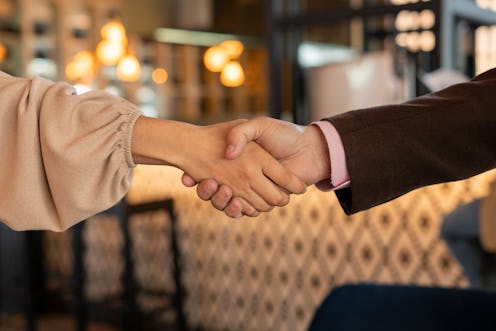 man and woman shake hands for having closed important business