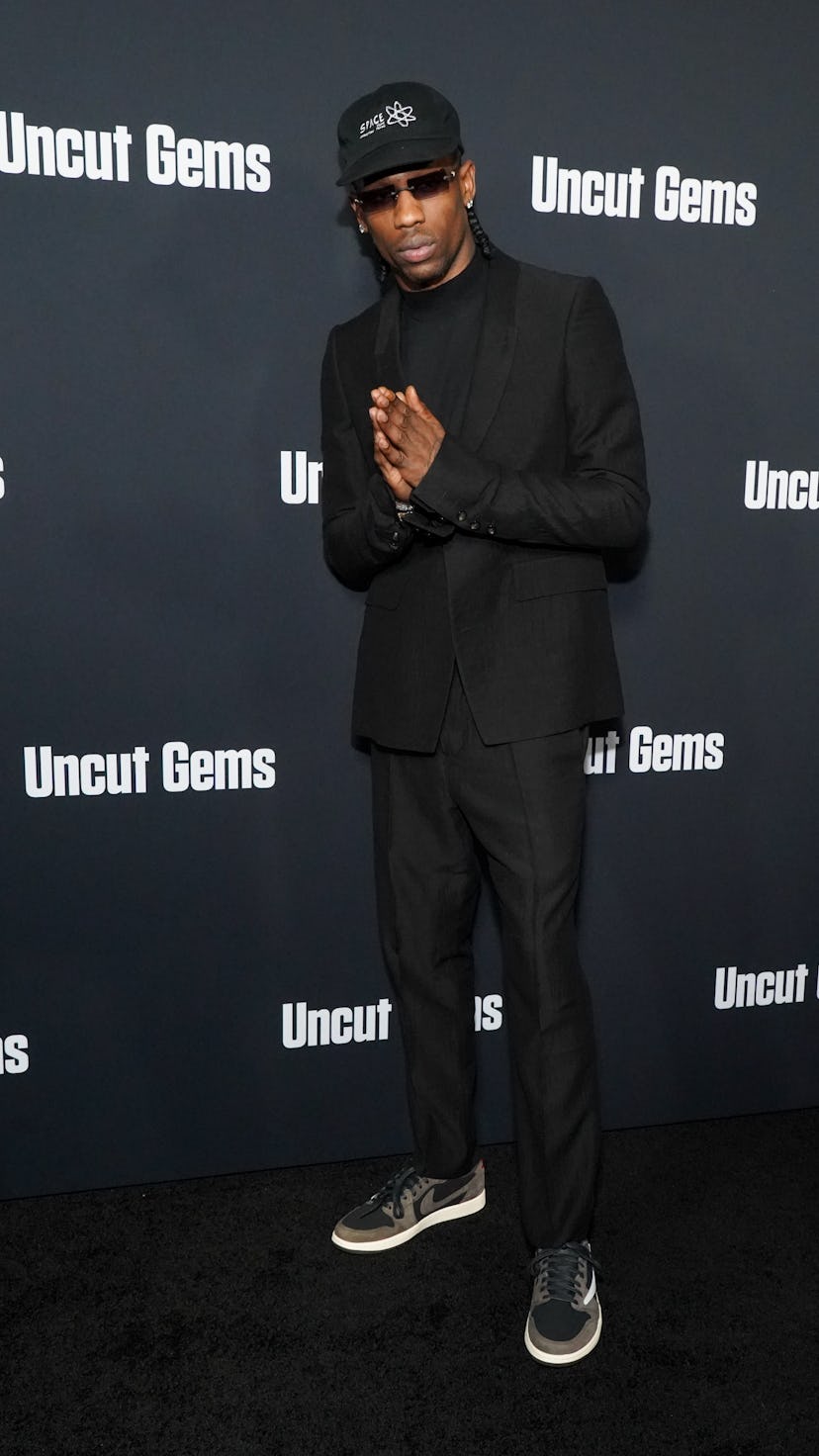 HOLLYWOOD, CALIFORNIA - DECEMBER 11: Travis Scott attends the premiere of A24's "Uncut Gems" at The ...