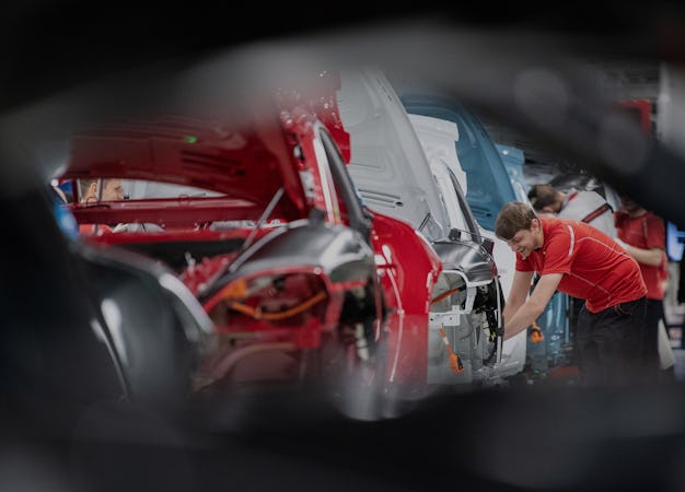 04 March 2020, Baden-Wuerttemberg, Stuttgart: Employees of Porsche AG assemble Porsche Taycan in pro...