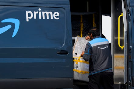 An Amazon.com Inc. delivery driver loads a van outside of a distribution facility on February 2, 202...
