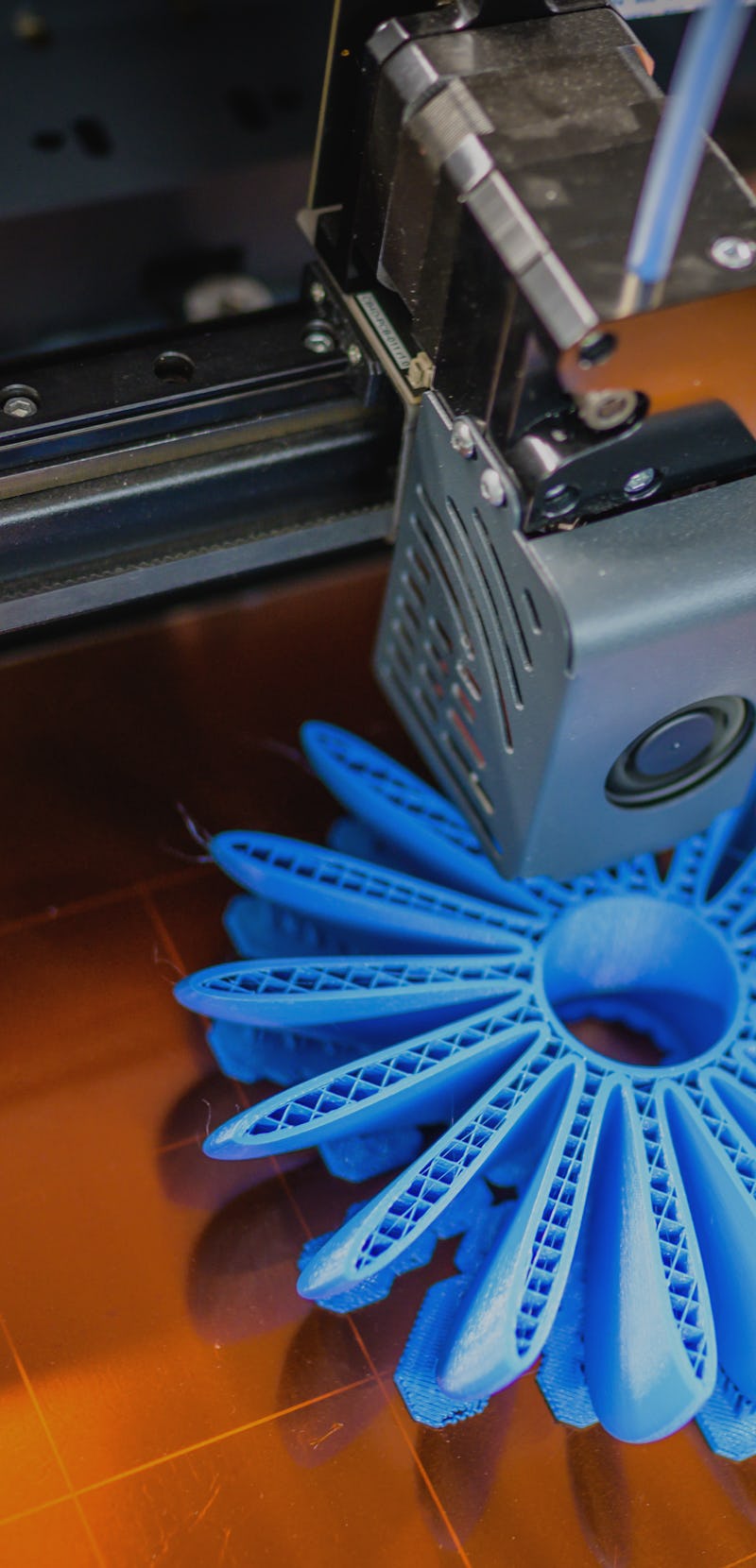 High angle view of plastic fan propeller 3D printing process.