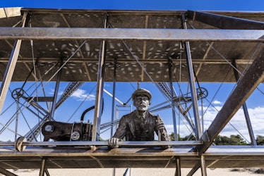 Sculpture of historic first flight at Wright Brothers National Memorial in Kill Devil Hills. (Photo ...