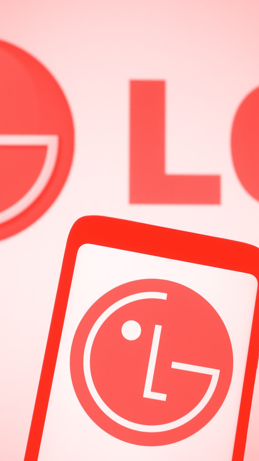 UKRAINE - 2021/03/15: In this photo illustration, LG logo seen displayed on a smartphone and a pc sc...