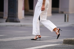 PARIS, FRANCE - MAY 14: A passerby wears white jeans, bejeweled pointy shoes, in the streets of Pari...