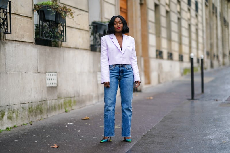 PARIS, FRANCE - DECEMBER 12: Carrole Sagba wears a pale purple / mauve blazer cropped jacket from Le...