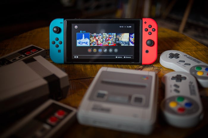 BANGKOK, THAILAND - 2019/01/08: In this photo illustration, a Nintendo Switch (M) surrounded by a N...
