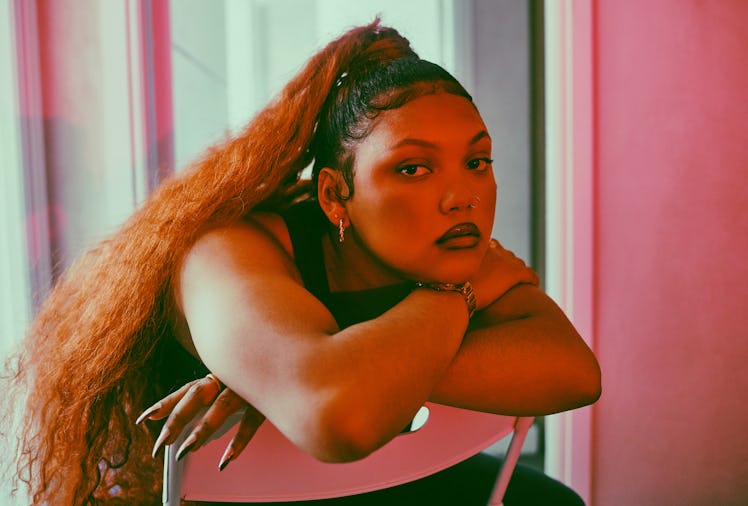 Shot of a fashionable young woman posing under red lighting