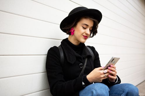 Portrait of smiling young woman using smart phone