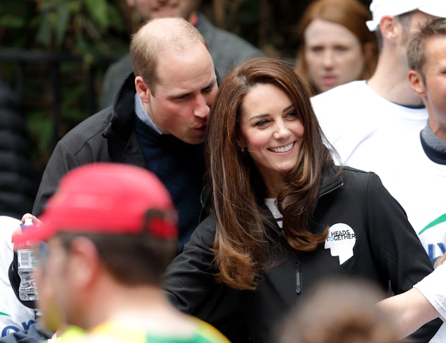 Prince William whispers to Kate Middleton.