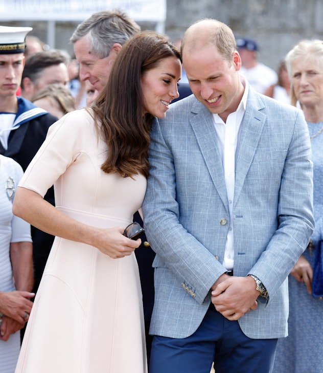 Kate Middleton whispers to Prince William.