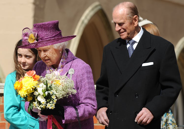 Britain's Queen Elizabeth II (R) and Prince Philip, the Duke of Edinburgh (L) leave after attending ...