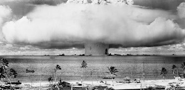 This view from the shore at Bikini shows the explosion of the atomic bomb in underwater test of July...