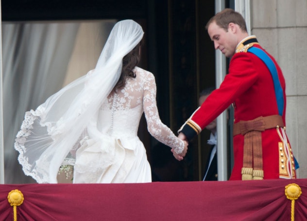 Prince William holds Kate Middleton's hand.