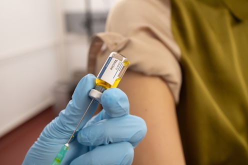 Doctor giving a Covid-19 vaccine to a female patient. When you eventually need a COVID vaccine boost...