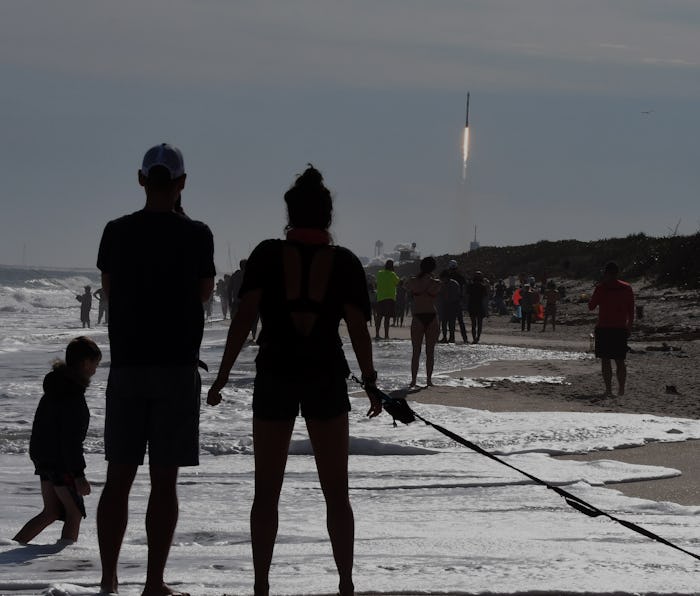 Brandon and Heather Arentson (from left) of Atlanta, Georgia watch from the beach at Canaveral Natio...