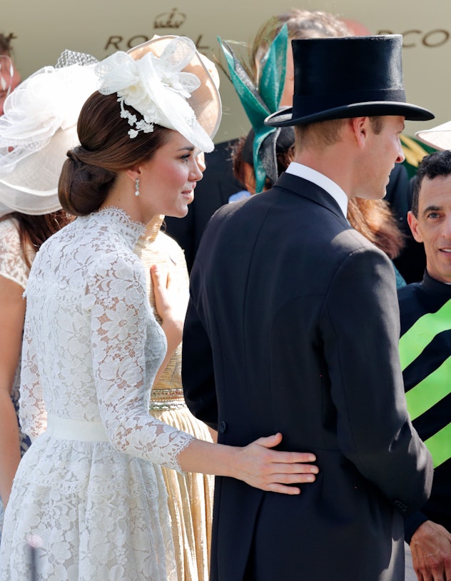 Kate Middleton wraps her arm around Prince William.