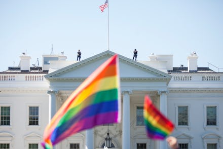 WASHINGTON, DC - JUNE 11: Demonstrators carry rainbow flags past the White House during the Equalit...